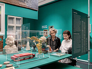 Eine Frau und ein Mädchen sehen sich Ausstellungsstücke an. 