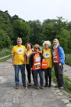 Eine Gruppe aus 5 Personen posiert auf einem Wanderweg