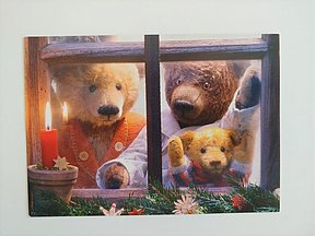 Weihnachtskarte mit drei Bären die aus dem Fenster schauen