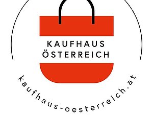 Ein kreisförmiges Logo mit einer rot-weiß-roten Einkaufstasche in der Mitte. Auf der Einkaufstasche steht "Kaufhaus Österreich", darunter "kaufhaus-oesterreich.at".